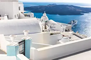 White wash staircases on Santorini Island, Greece. The view toward Caldera sea with cruise ship awaiting. Luxury summer travel, dream vacation