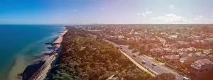 Wide aerial landscape of Black Rock suburb with Melbourne CBD skyscrapers on the horizon