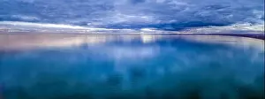 Calm Waters Prints: Wide aerial panorama of stormy clouds over smooth ocean water surface