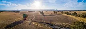 Travel Locations Prints: Wide aerial panoramic landscape of Australian outback at sunset with lens flare