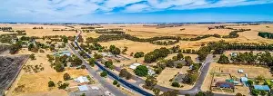 Agricultural Land Prints: Wide aerial panoramic landscape of rural road passing through small township of Streatham in Victoria