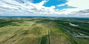 Diminishing Perspective Prints: A very wide aerial view of farmland and rural wisconsin in spring under a cloudy blue sky