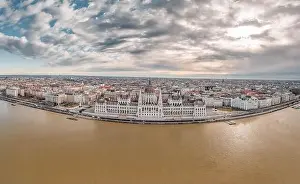 Morning Glow Prints: Wide angle aerial drone shot of Hungarian Parliament with clouds in Budapest Winter morning