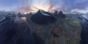 Wide angle aerial view of majestic mountains located near calm lake in evening time in Iceland