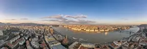 Wide panorama aerial drone view of Parliament by danube river in Budapest sunset