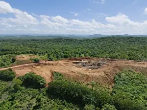 Quarrying Prints: Wide mine quarry on green natural landscape aerial drone view on sunny day