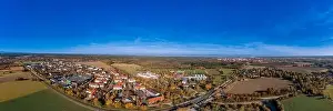 Feel Prints: Wide view over the bavarian city Oberhaching in colors of the indian summer as panoramic aerial photo