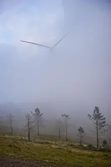 Wind turbines renewable energy on the middle of clouds in Serra da Lousa, Portugal