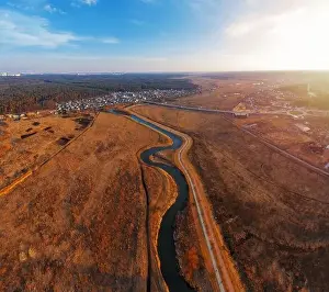 Turns Prints: Winding river in field with dry grass. Autumn landscape from aerial view
