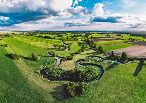 A winding river surrounded by green meadows