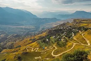 Serpentine Road Prints: Winding road in the Dagestan Mountains with big mountain formation in the background