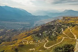 Serpentine Road Prints: Winding road in the Dagestan Mountains with big mountain formation in the background