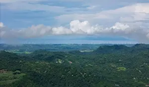Windmills Prints: Many windmills next tol lake on green mountain landscape aerial drone view