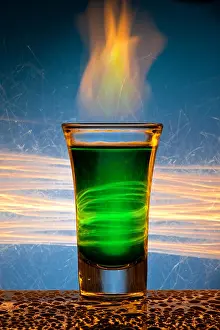 Tasting Prints: The wine-glass for a cocktail with alcohol of green colour against Bengal fires with reflexion