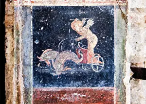 Pompeii Prints: Winged Amorino leads a fish-drawn chariot, a figure of divinity of ancient Rome in Pompeii