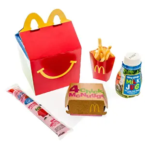 Illustrative Editorial Prints: Winneconne, WI - 7 August 2018: A Chicken McNuggets happy meal with white milk and yogurt on an isolated background