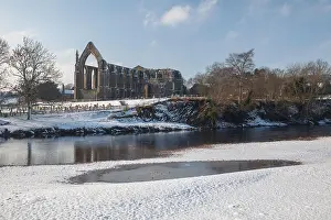 Abbey Prints: Winter view of Bolton Priory, the River Wharfe and its stepping stones after snow