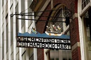 Wise Prints: The Wise Men Fish Here sign hanging outside of the Gotham Book Mart