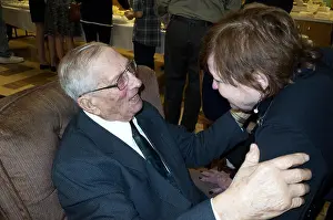Citizens Prints: Woman age 75 greets her 95 year old cousin at his birthday party