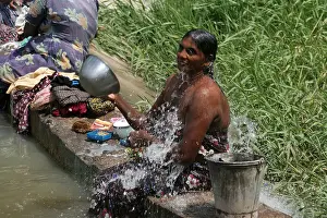 Cultural Travel Prints: Woman bathing in the rural countryside of Sri Lanka