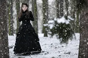 Young Girl Prints: Woman in black Victorian dress in the winter park