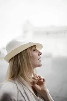 Rome Italy Prints: A woman with blonde hair wearing a cream panama hat
