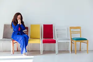 Weekends Prints: Woman in blue sitting on chairs in room interior