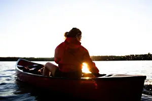Three Quarter Prints: A woman canoes on Cobbosseecontee Lake, in southern Maine