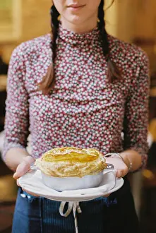 Young Adult Woman Prints: A woman carrying a fresh baked pastry topped pie on a plate