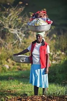 40 45 Years Prints: A woman carrying washing on her head