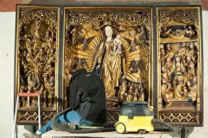 Medieval Art Prints: Woman conservator cleaning a medieval tryptich at the Heiligen-Geist-Hospital