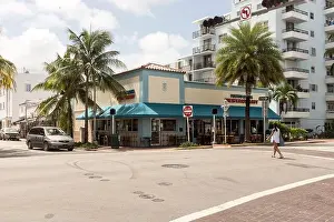 Miami Prints: A woman crosses the street in front of Puerto Sagua Cuban restaurant in Miami Beach