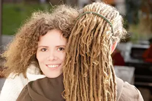 Lengths Prints: Woman with curly hair smiling and a man with dreadlocks