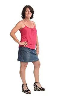 woman with denim skirt on white background, hand son hip