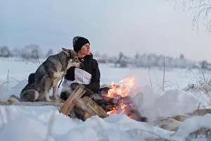 Three Quarter Prints: Woman with dog sitting at camp fire