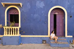 Cartagena Prints: A woman in a doorway on the colourful streets of Getsemani, Cartagena, Colombia