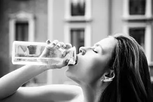 Refresh Prints: Woman drinking water. Sensual young girl outdoor
