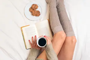 Socks Prints: Woman eating breakfast in bed while reading a book