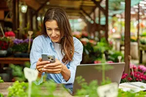 Engaged Prints: A woman is engaged in digital work while surrounded by the beauty of nature and greenery