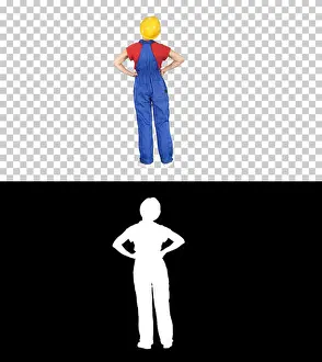 Backside Prints: Woman engineer in construction helmet stands with hands on hips, Alpha Channel