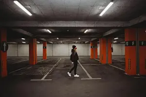 Face Mask Prints: woman with facial mask walking in empty parking garage with neon lights