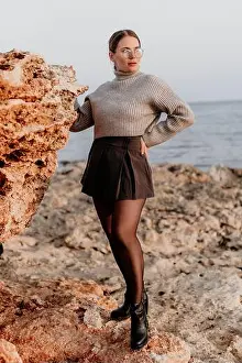 Skirt Prints: Woman Fashion Rocks Coastal Autumn Photoshoot: Stylish model poses near rocks