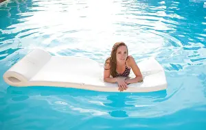Solemn Prints: Woman floating on raft in swimming pool