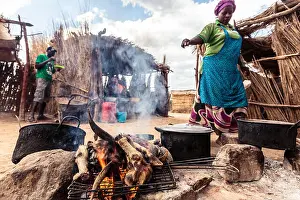 Namibia Prints: Woman grilling goat legs and head at the market in Opuwo, Kunene, Namibia, Africa