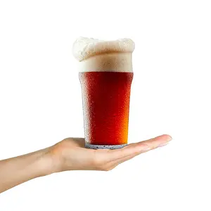 Guinness Prints: Woman hand holding mug of beer with foam on white background