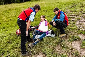 Wander Prints: Woman being helped by mountain rescue team after breaking her arm after hiking in the Bavarian Alps
