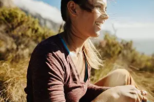 Trekker Prints: Woman hiker sitting on cliff and looking away at the view