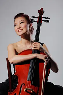 Chinese Ethnicity Prints: Woman holding a cello and smiling