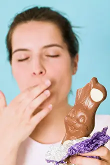 Grown Up Prints: Woman holding chocolate Easter Bunny with a bite taken -