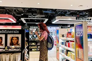 Perfume Prints: A woman looks at perfume on sale at Dublin Airport duty free store. Ireland
